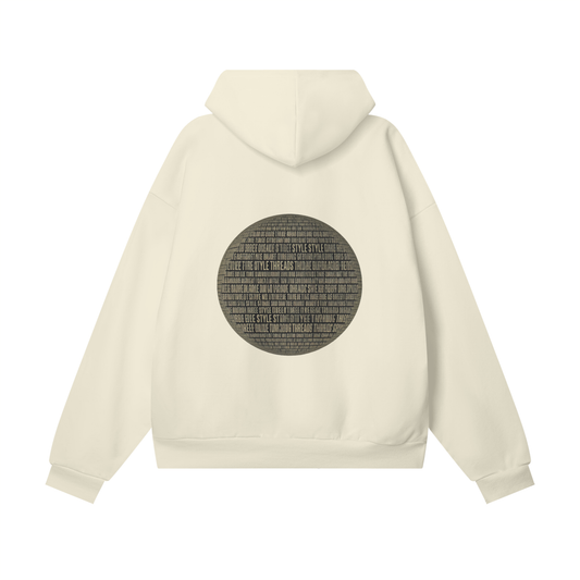 Beige oversized heavyweight hoodie with a black circular graphic design on the back, made from premium organic fleece.