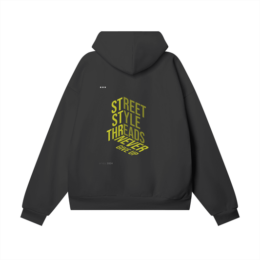 "Street Style Threads hoodie featuring the 'Never Give Up' graphic on the front, oversized streetwear fit, soft brushed fleece interior, ribbed cuffs and hem, available in multiple colors.