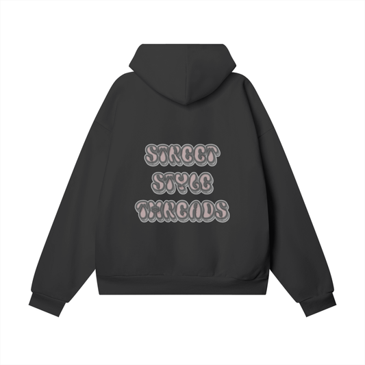 Black heavyweight streetwear hoodie featuring graffiti-inspired logo print in pink on the back.