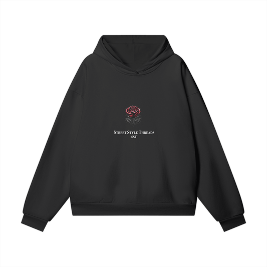 Black SST hoodie showcasing a vibrant rose graphic on the front, oversized fit, warm soft fleece lining, ribbed cuffs and hem for a snug fit.